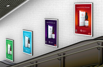 Advertisements for flavored wellness products displayed on a tiled wall in a stairwell.
